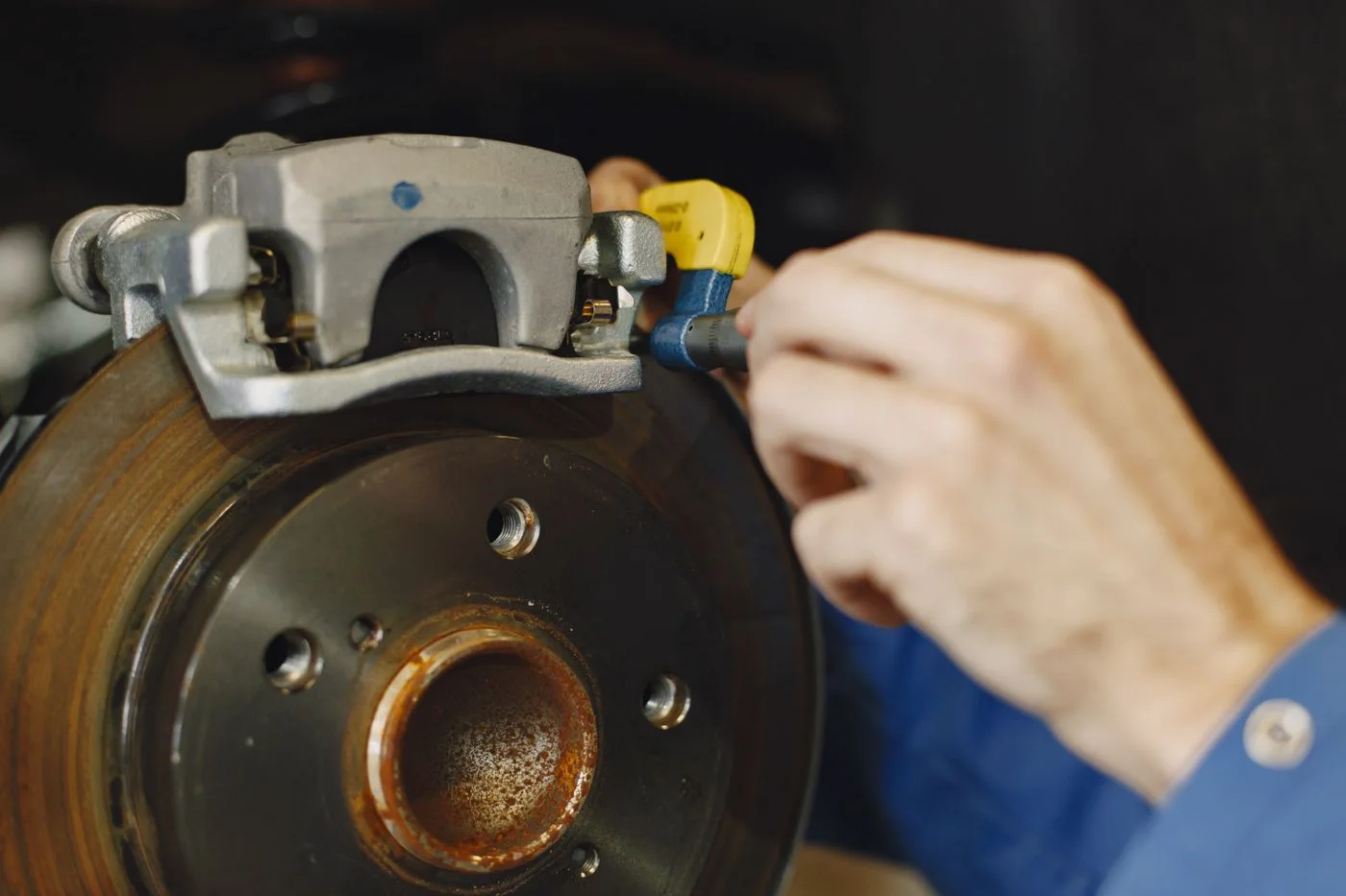 Disc brake assembly — Rotor, hub, and caliper details in a service setting.